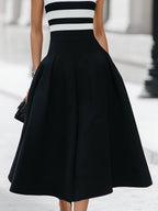 Vestido midi elegante de corte A, sin mangas, a rayas, con bolsillos