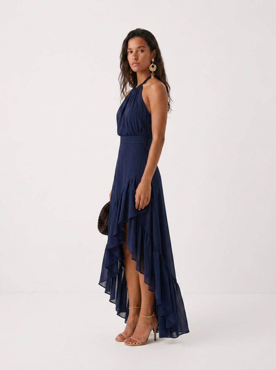 Elegante vestido de invitada de boda azul con cuello halter y bajo asimétrico de volantes