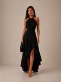 Elegante vestido de invitada de boda con negro cuello halter y bajo asimétrico de volantes